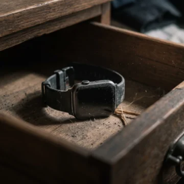english-shadowing-exercises-digital-lifestyle A dusty smart watch left forgotten inside an old wooden drawer for a C1 English listening lesson on Listenglish.